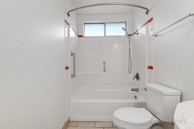 bathroom with toilet, a textured wall, tub / shower combination, and tile patterned flooring