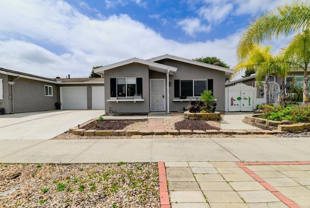 ranch-style house with stucco siding, driveway, an attached garage, and a gate