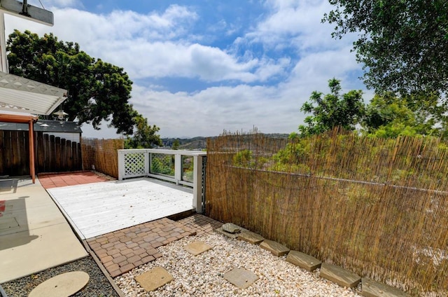 view of patio / terrace with fence and a wooden deck