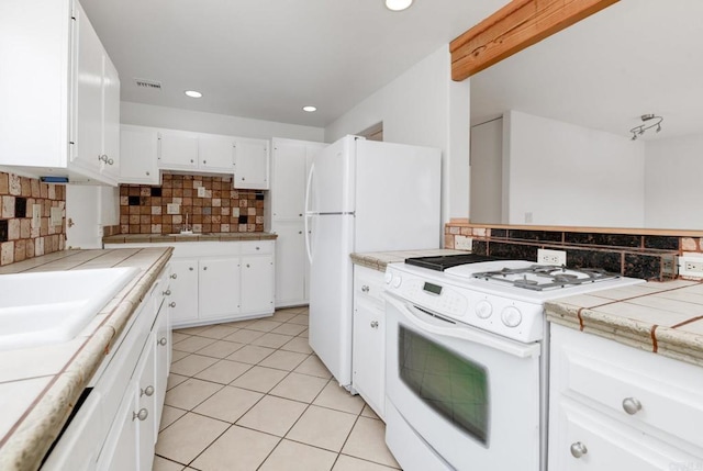 kitchen with white appliances, tile countertops, light tile patterned flooring, decorative backsplash, and recessed lighting