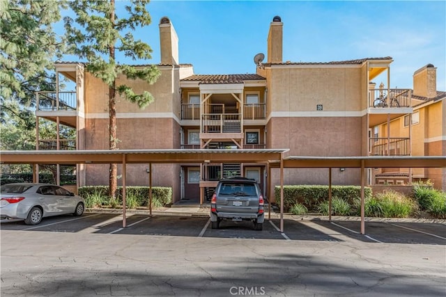 view of property featuring covered parking