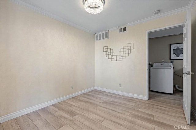 unfurnished room with light wood-style floors, crown molding, baseboards, a smoke detector, and washing machine and clothes dryer