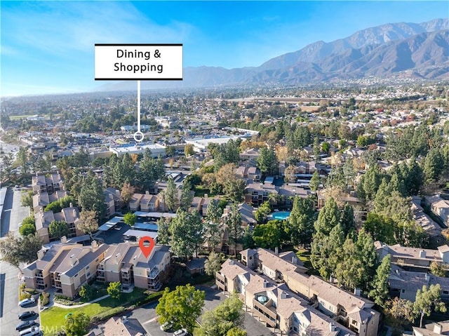 aerial view of property's location featuring mountains and nearby suburban area