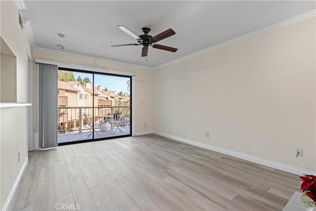 spare room with wood finished floors, ceiling fan, baseboards, and crown molding