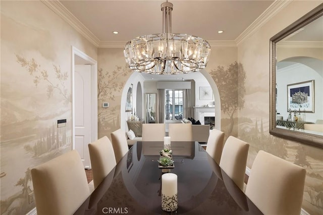 427 10th St, Huntington Beach, CA 92648 - dining room featuring arched walkways, wallpapered walls, crown molding, a chandelier, and a fireplace