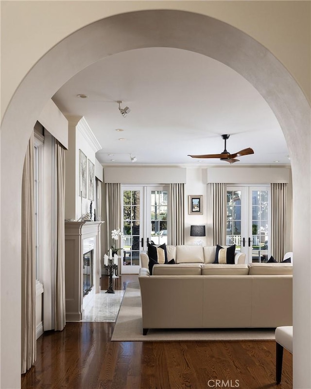 427 10th St, Huntington Beach, CA 92648 - living area with ceiling fan, arched walkways, french doors, a glass covered fireplace, and wood finished floors