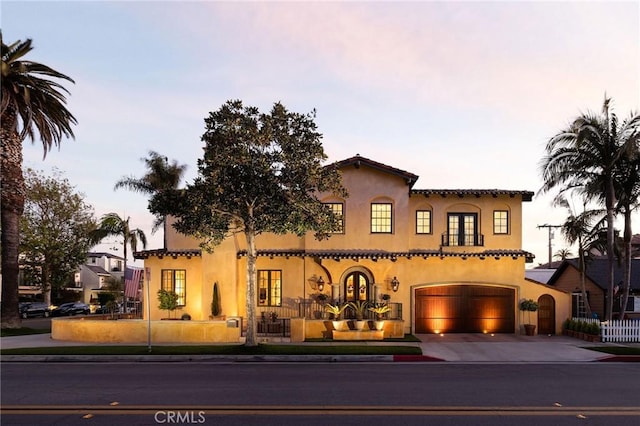 427 10th St, Huntington Beach, CA 92648 - mediterranean / spanish home featuring driveway, a fenced front yard, and stucco siding