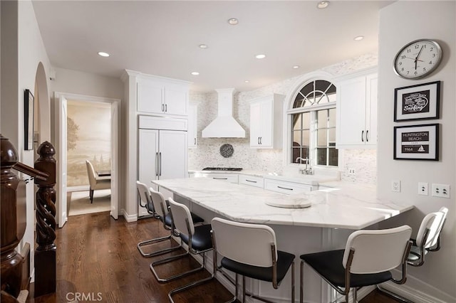 427 10th St, Huntington Beach, CA 92648 - kitchen featuring custom exhaust hood, paneled built in refrigerator, white cabinetry, light stone countertops, and recessed lighting