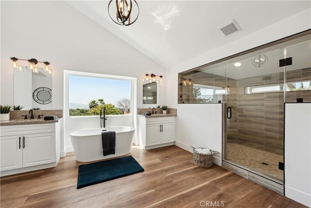 529 Manzanita Rd, Redlands, CA 92373 - full bathroom with lofted ceiling, a shower stall, two vanities, wood finished floors, and a soaking tub