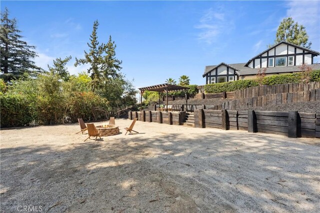 529 Manzanita Rd, Redlands, CA 92373 - view of yard featuring a fire pit, a pergola, and fence