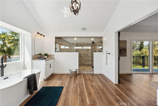 529 Manzanita Rd, Redlands, CA 92373 - full bathroom with vaulted ceiling, healthy amount of natural light, a stall shower, vanity, and wood finished floors