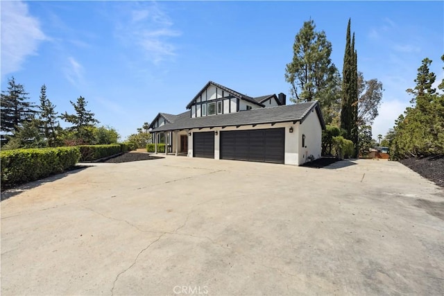 529 Manzanita Rd, Redlands, CA 92373 - view of home's exterior with concrete driveway, a tile roof, an attached garage, stucco siding, and a garage