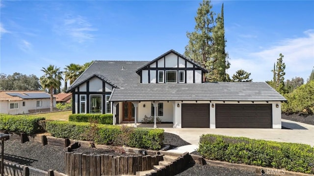 529 Manzanita Rd, Redlands, CA 92373 - english style home featuring driveway, a garage, stucco siding, and a tiled roof