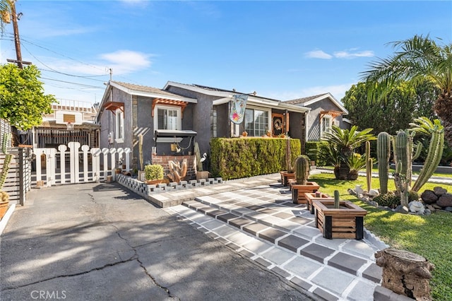 10521 Asher St, El Monte, CA 91733 - view of front facade with fence, stucco siding, and a patio area