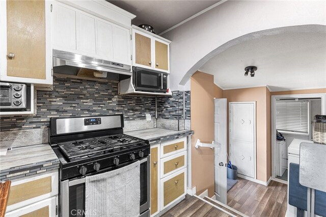 10521 Asher St, El Monte, CA 91733 - kitchen with stainless steel gas range, under cabinet range hood, ornamental molding, wood finished floors, and arched walkways
