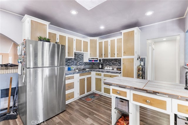 10521 Asher St, El Monte, CA 91733 - kitchen with freestanding refrigerator, dark wood-style flooring, decorative backsplash, arched walkways, and recessed lighting