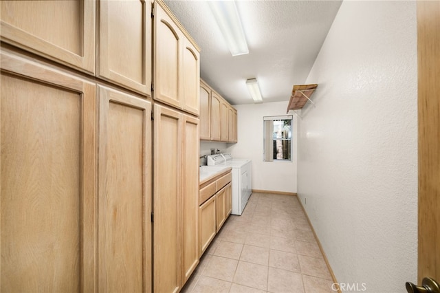 laundry area featuring cabinet space, light tile patterned floors, separate washer and dryer, and baseboards