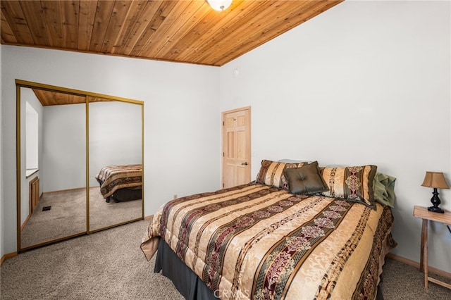 carpeted bedroom with wood ceiling, a closet, and baseboards