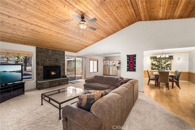 living room featuring wooden ceiling, a chandelier, healthy amount of natural light, a fireplace, and a ceiling fan