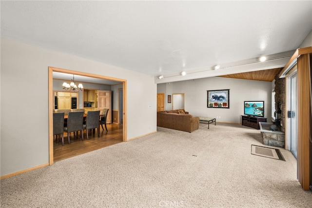 living area with carpet, a chandelier, and baseboards