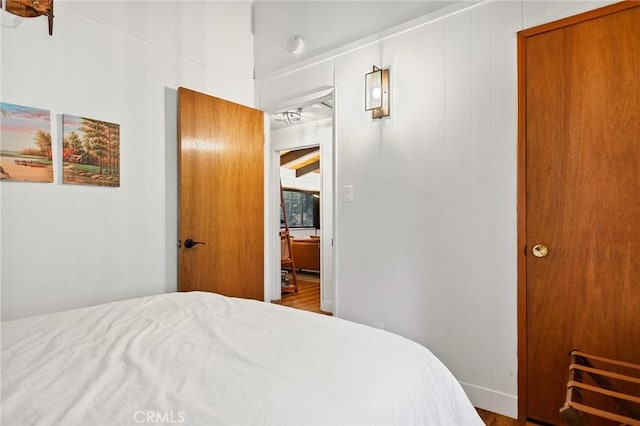 bedroom featuring wood finished floors and baseboards