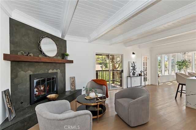 27757 N Bay Rd, Lake Arrowhead, CA 92352 - living room featuring beamed ceiling, wood finished floors, plenty of natural light, and a fireplace