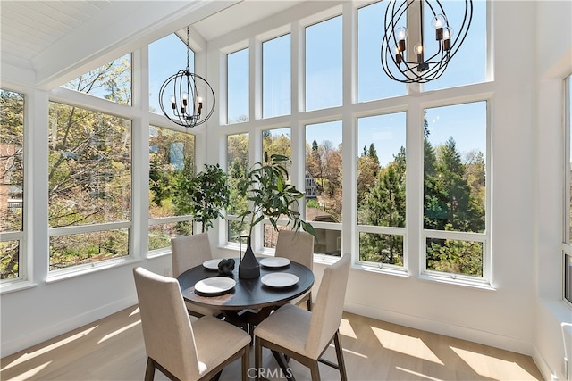 27757 N Bay Rd, Lake Arrowhead, CA 92352 - sunroom with a chandelier, plenty of natural light, a high ceiling, baseboards, and wood finished floors