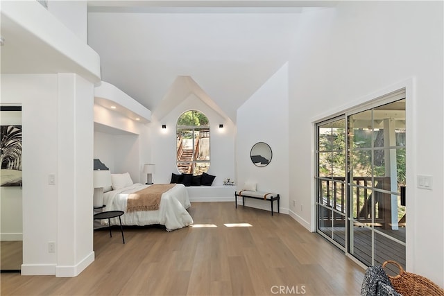 27757 N Bay Rd, Lake Arrowhead, CA 92352 - bedroom featuring multiple windows, light wood-style flooring, access to exterior, and high vaulted ceiling