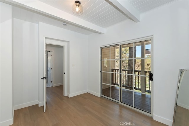 27757 N Bay Rd, Lake Arrowhead, CA 92352 - empty room featuring beamed ceiling, wood finished floors, and baseboards