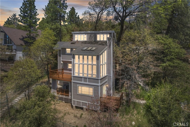 27757 N Bay Rd, Lake Arrowhead, CA 92352 - rear view of house featuring view of scattered trees, a balcony, and a deck