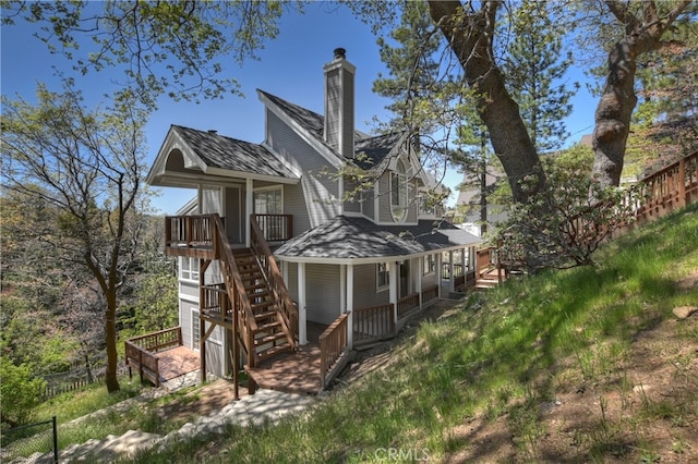 27757 N Bay Rd, Lake Arrowhead, CA 92352 - view of side of home with a chimney, stairway, covered porch, and fence