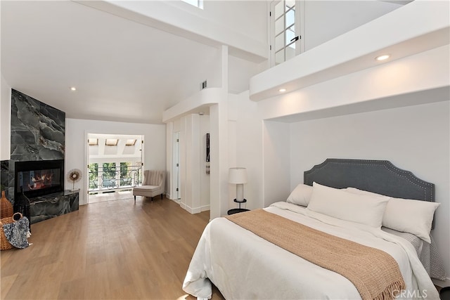 27757 N Bay Rd, Lake Arrowhead, CA 92352 - bedroom featuring wood finished floors, a high ceiling, a high end fireplace, and recessed lighting