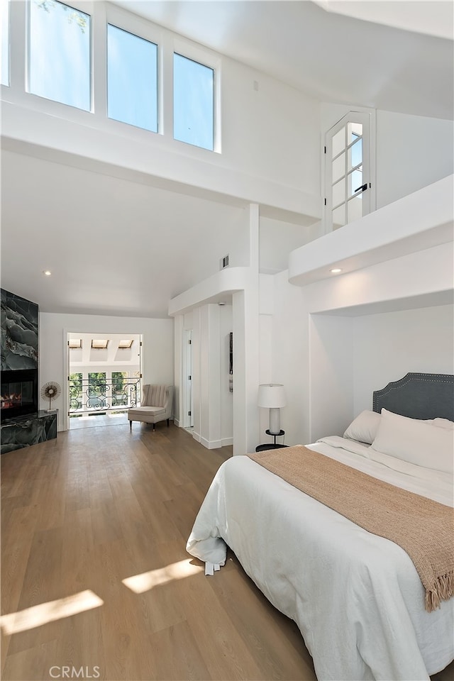 27757 N Bay Rd, Lake Arrowhead, CA 92352 - bedroom with a towering ceiling, wood finished floors, a high end fireplace, and recessed lighting
