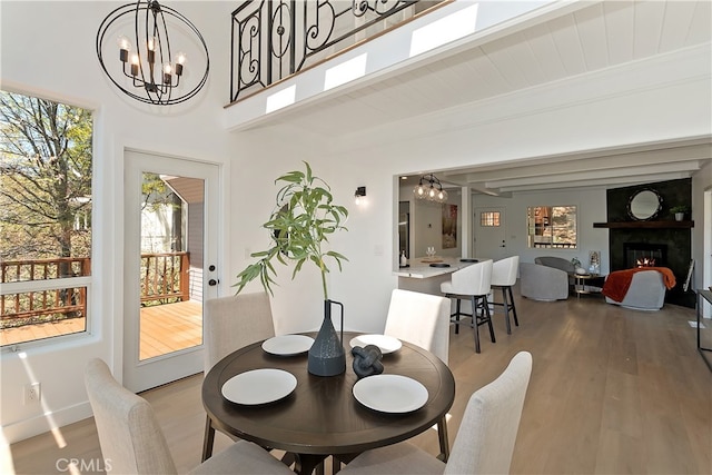 27757 N Bay Rd, Lake Arrowhead, CA 92352 - dining room with a chandelier, plenty of natural light, light wood finished floors, and beam ceiling