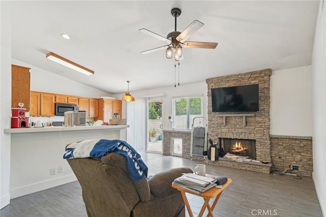 2925 Greenbriar Dr, Ontario, CA 91761 - living room with vaulted ceiling, a stone fireplace, a ceiling fan, and wood finished floors