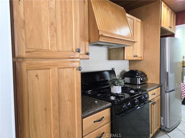 2149 Clover St, Simi Valley, CA 93065 - kitchen with gas stove, freestanding refrigerator, custom exhaust hood, light tile patterned flooring, and dark stone countertops