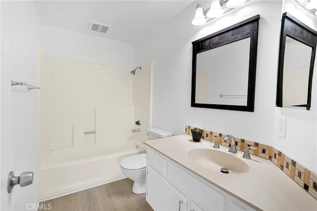 14359 Birchwood Dr, Hesperia, CA 92344 - bathroom featuring toilet, wood finished floors, vanity, and shower / bath combination