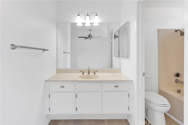 14359 Birchwood Dr, Hesperia, CA 92344 - bathroom with toilet, ceiling fan, vanity, shower / tub combination, and wood finished floors