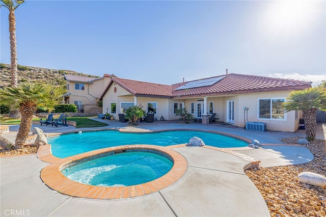 view of pool featuring a patio area and a pool with connected hot tub