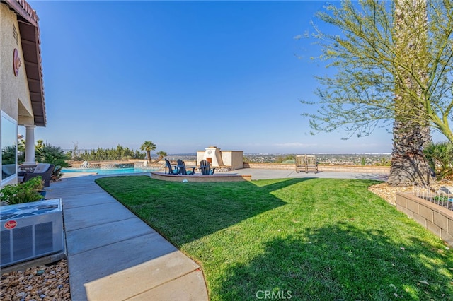 view of green lawn featuring an outdoor pool, central AC unit, and a patio area