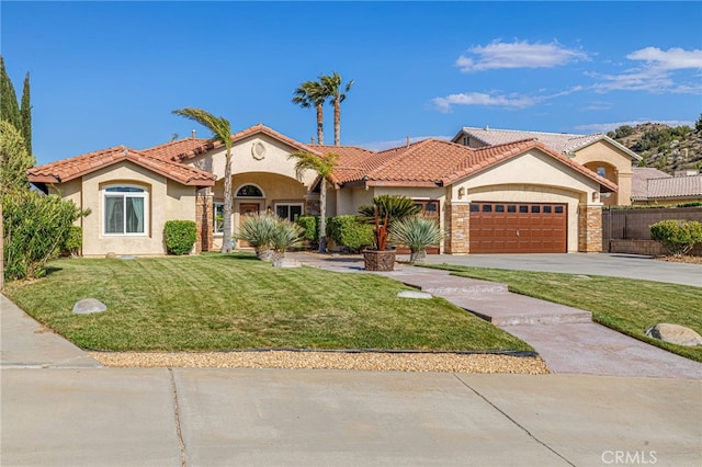 mediterranean / spanish house with stucco siding, a garage, driveway, and a tile roof