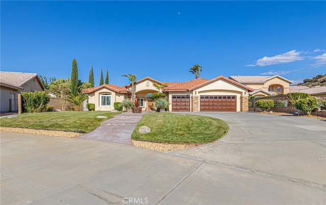 mediterranean / spanish house featuring stucco siding, an attached garage, driveway, and a tiled roof