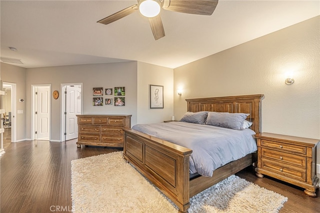bedroom with dark wood-style floors, ceiling fan, and baseboards