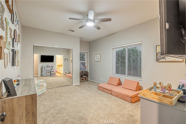 carpeted living room with a ceiling fan