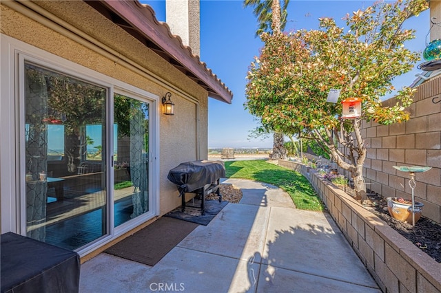 view of patio / terrace featuring a grill and fence