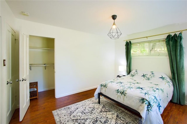 18041 Acre St, Northridge, CA 91325 - bedroom with wood finished floors, baseboards, a closet, and a walk in closet