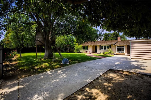 18041 Acre St, Northridge, CA 91325 - view of front of home with a chimney, concrete driveway, and board and batten siding