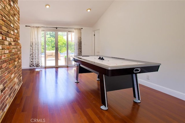 18041 Acre St, Northridge, CA 91325 - playroom featuring wood finished floors, vaulted ceiling, baseboards, brick wall, and recessed lighting