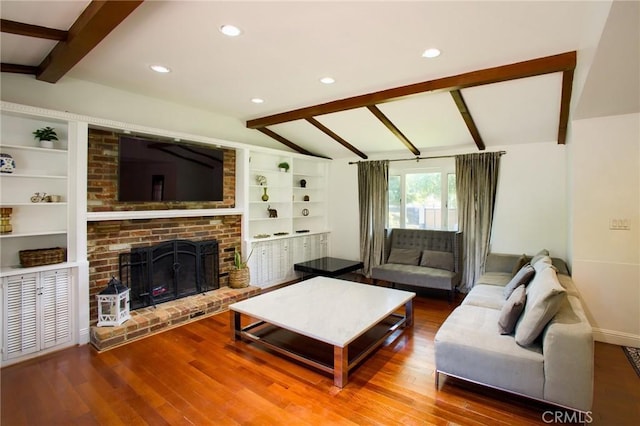 18041 Acre St, Northridge, CA 91325 - living area featuring wood finished floors, built in shelves, baseboards, a brick fireplace, and recessed lighting