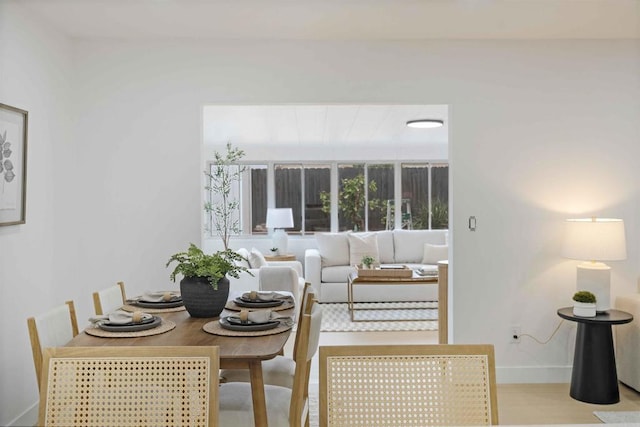 dining space featuring wood finished floors and baseboards